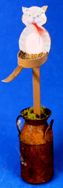 (image for) Cat themed birdfeeder in rusty milk container